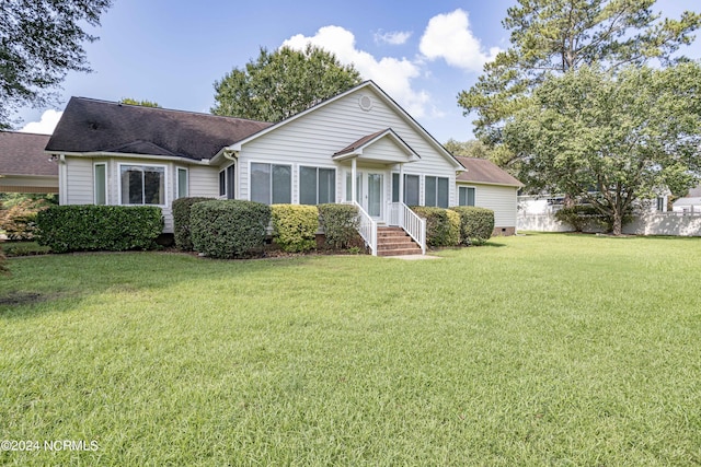 ranch-style house featuring a shingled roof, crawl space, fence, and a front lawn