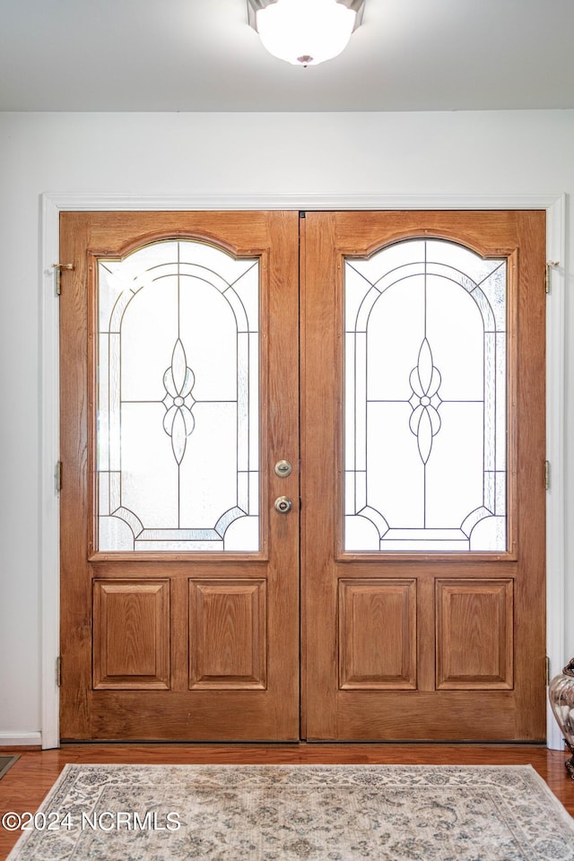 foyer entrance with a wealth of natural light and wood finished floors