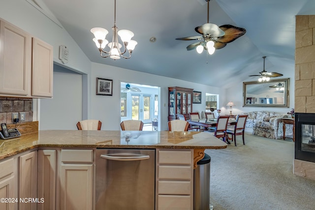 kitchen featuring ceiling fan with notable chandelier, carpet floors, vaulted ceiling, and light brown cabinetry