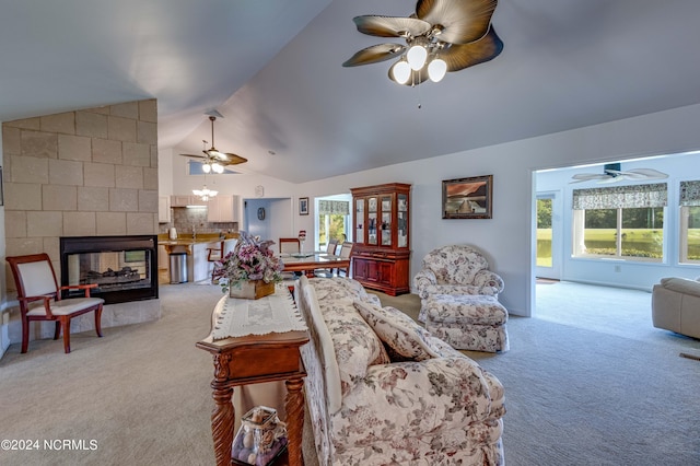 living area featuring lofted ceiling, light colored carpet, and ceiling fan