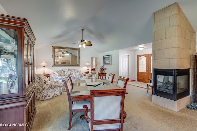 dining space with vaulted ceiling, carpet, and a multi sided fireplace