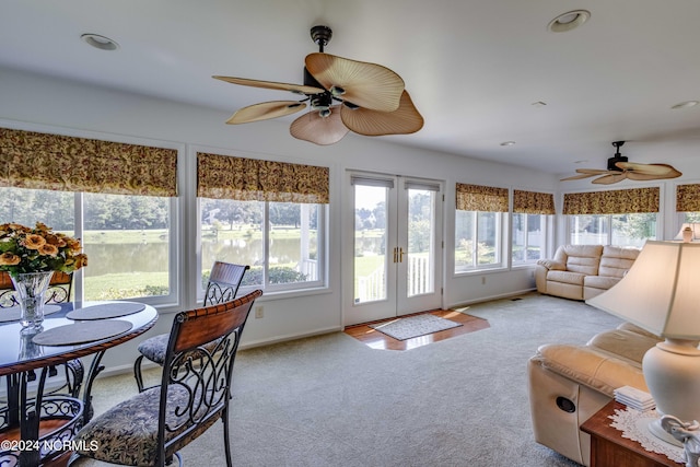 sunroom featuring ceiling fan and french doors