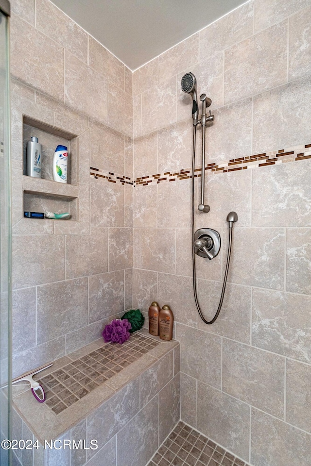 bathroom with a tile shower