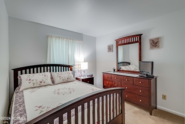 bedroom featuring light colored carpet