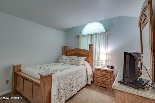 bedroom with light carpet and lofted ceiling