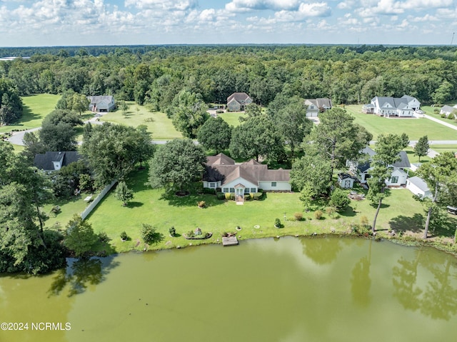 aerial view featuring a forest view and a water view