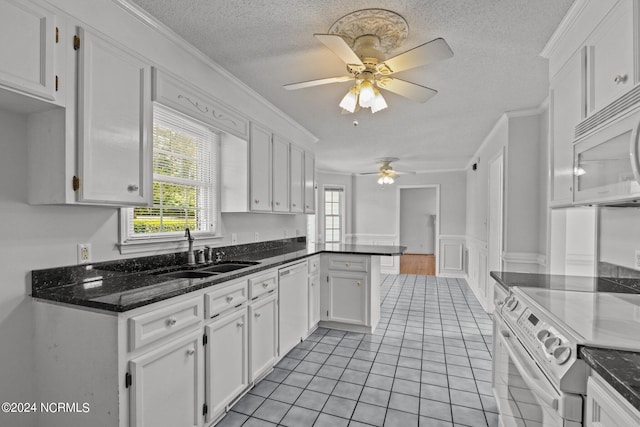 kitchen with ceiling fan, ornamental molding, white cabinets, light tile patterned floors, and white appliances