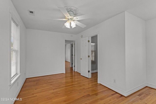 spare room with ceiling fan and light wood-type flooring