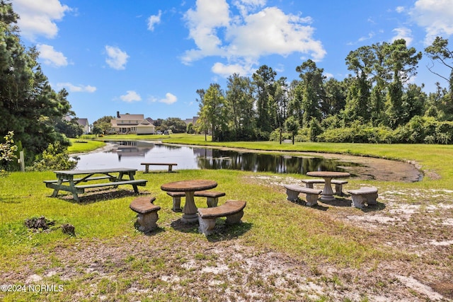 exterior space featuring a water view and a lawn