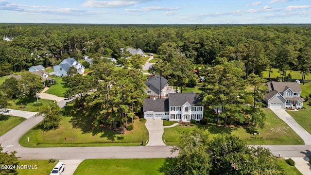 drone / aerial view with a residential view and a view of trees