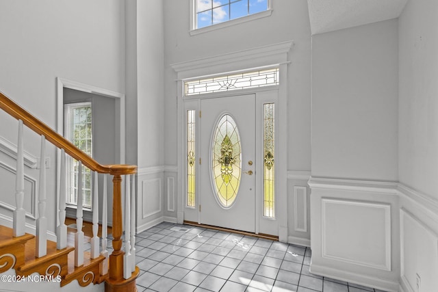 tiled entrance foyer with plenty of natural light and a towering ceiling