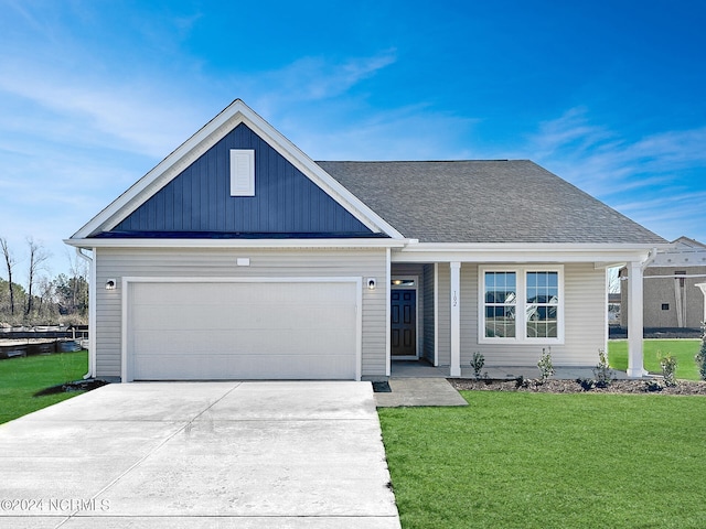 view of front of home with a front yard and a garage