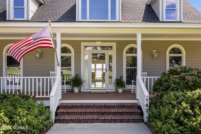 view of exterior entry with covered porch