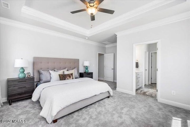 carpeted bedroom with baseboards, a tray ceiling, and ornamental molding