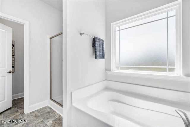 full bath with a stall shower, plenty of natural light, and a garden tub