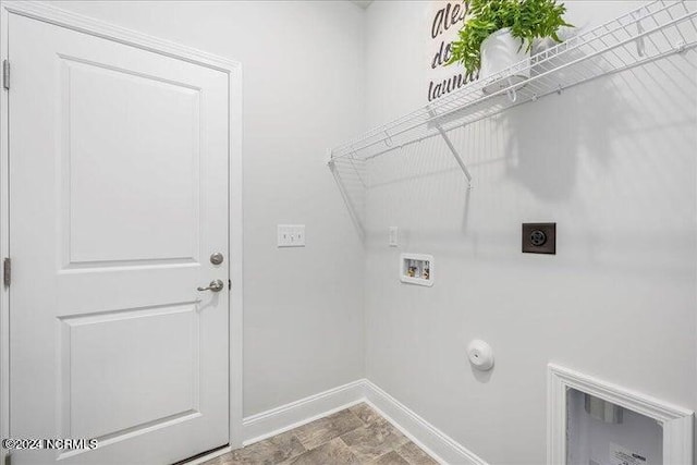 clothes washing area featuring gas dryer hookup, hookup for a washing machine, laundry area, baseboards, and electric dryer hookup