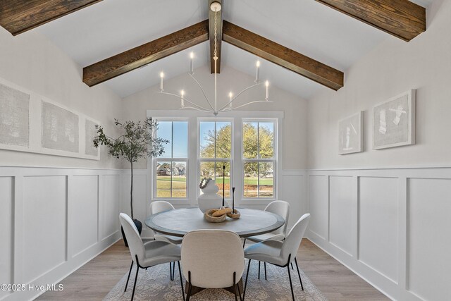 9307 Old Salem Way, Calabash, NC 28467 - dining room featuring a decorative wall, a chandelier, light wood-style floors, and wainscoting
