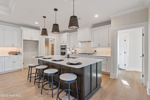 9307 Old Salem Way, Calabash, NC 28467 - kitchen with light wood finished floors, stainless steel appliances, a sink, decorative backsplash, and recessed lighting