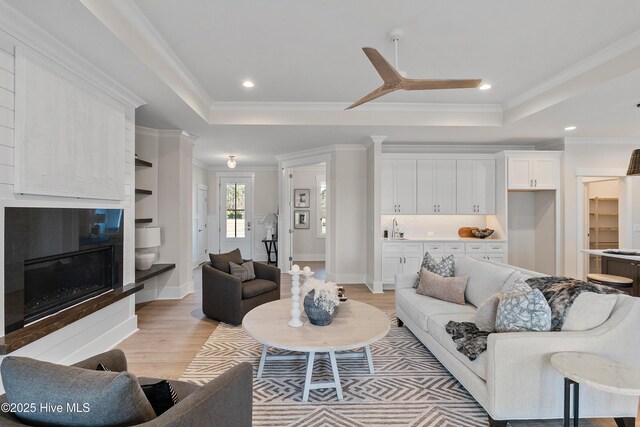 9307 Old Salem Way, Calabash, NC 28467 - living area with a tray ceiling, light wood-style floors, crown molding, and recessed lighting