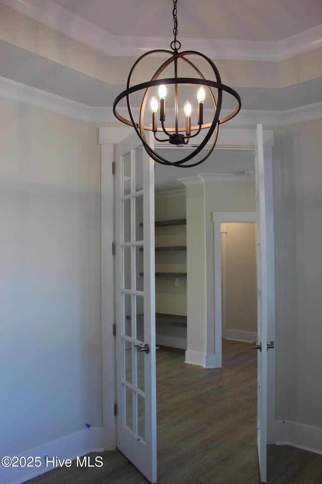 kitchen featuring dark wood-type flooring, sink, white cabinetry, hanging light fixtures, and ornamental molding