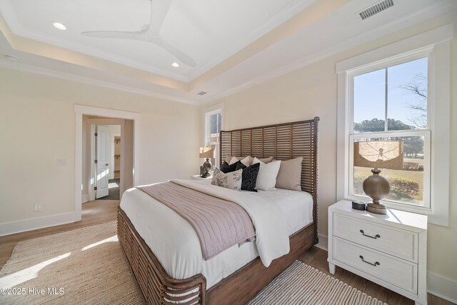 9307 Old Salem Way, Calabash, NC 28467 - bedroom featuring a raised ceiling, recessed lighting, wood finished floors, ornamental molding, and baseboards