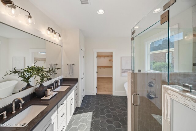 9307 Old Salem Way, Calabash, NC 28467 - full bath with double vanity, tile patterned flooring, a stall shower, a freestanding tub, and recessed lighting