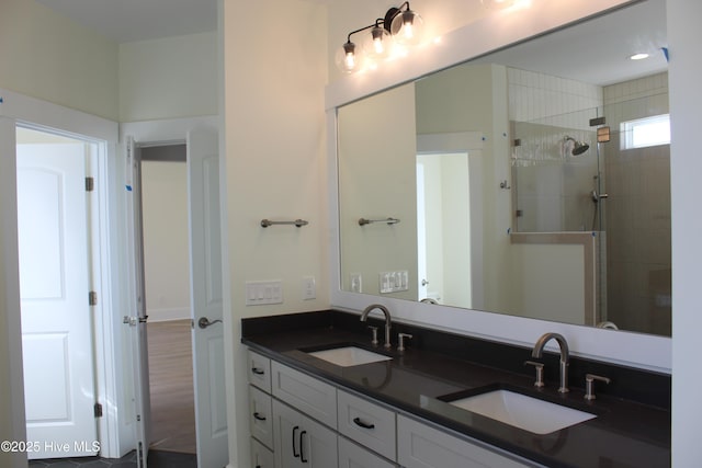 bathroom with vanity and a tile shower