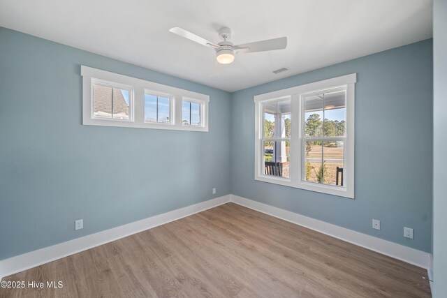 9307 Old Salem Way, Calabash, NC 28467 - unfurnished room with baseboards, wood finished floors, and a ceiling fan