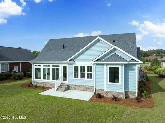 9307 Old Salem Way, Calabash, NC 28467 - back of house with a lawn, a patio, a shingled roof, and a sunroom