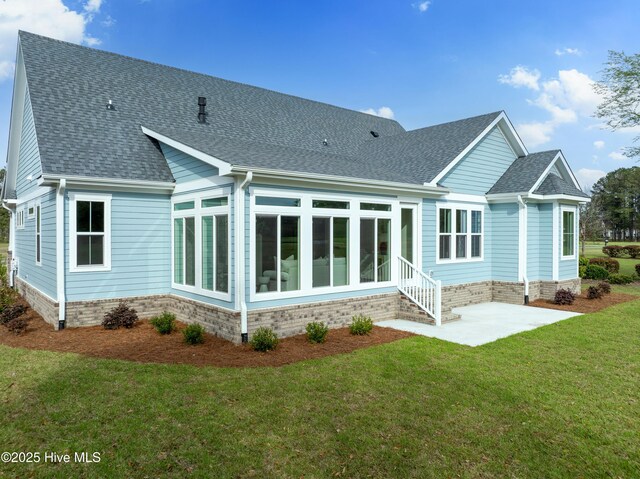 9307 Old Salem Way, Calabash, NC 28467 - back of property with a sunroom, a shingled roof, a lawn, and a patio area