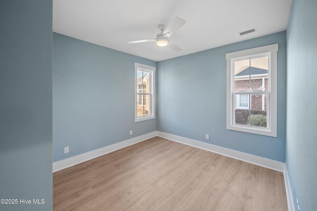 9307 Old Salem Way, Calabash, NC 28467 - unfurnished room featuring plenty of natural light, wood finished floors, ceiling fan, and baseboards