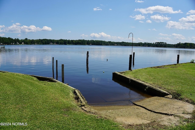 view of dock featuring a water view and a lawn