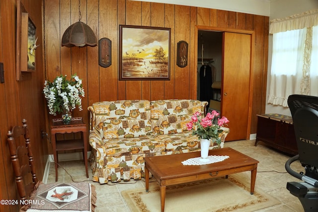 tiled living room featuring wooden walls