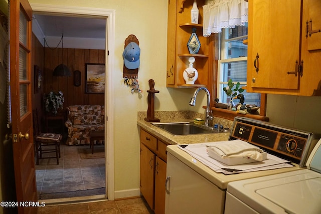 kitchen with sink, independent washer and dryer, and light tile patterned floors