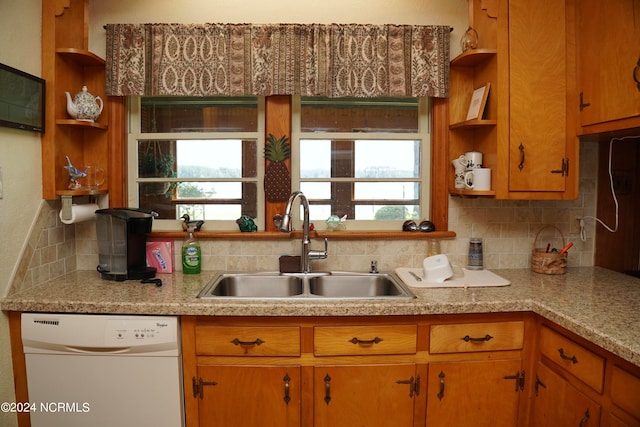 kitchen featuring dishwasher, tasteful backsplash, and sink