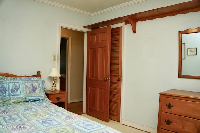 carpeted bedroom featuring a closet and ornamental molding