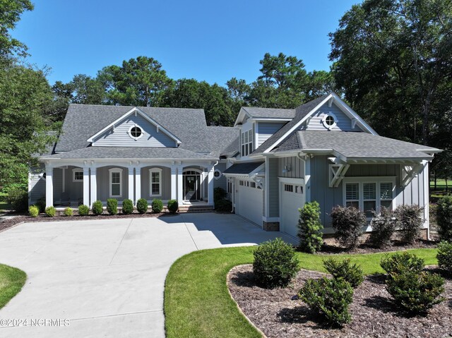 view of front of property with covered porch and a garage