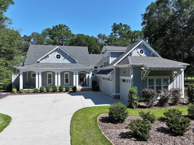 283 Golfview Ct SW, Supply, NC 28462 - view of front of house with concrete driveway, a porch, board and batten siding, and a shingled roof