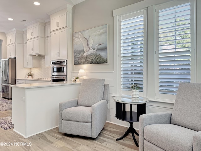 283 Golfview Ct SW, Supply, NC 28462 - kitchen featuring white cabinets, open floor plan, backsplash, light wood finished floors, and stainless steel fridge