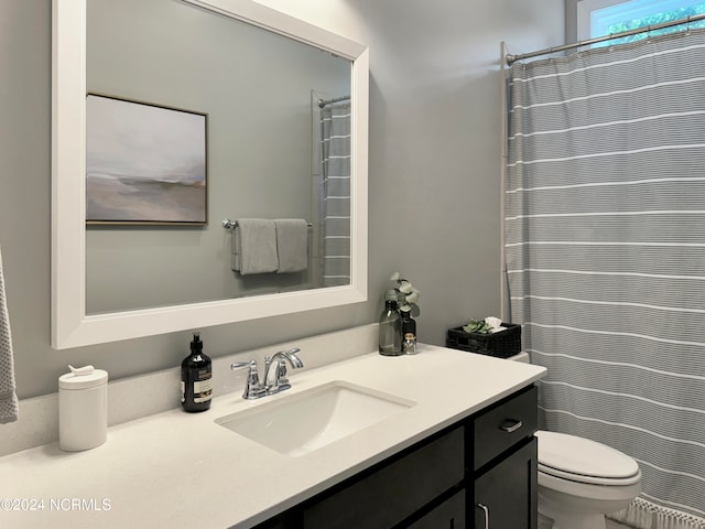 bathroom with vanity, toilet, and curtained shower