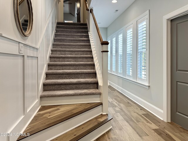 stairs featuring wood-type flooring