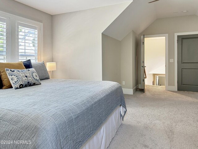 carpeted bedroom featuring vaulted ceiling