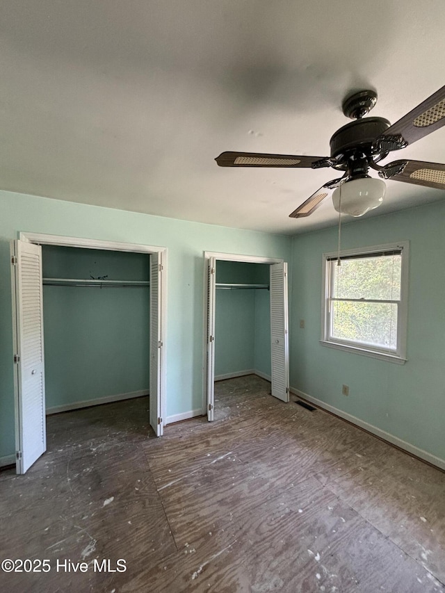 1208 S 9th St, Wilmington, NC 28401 - unfurnished bedroom featuring multiple closets, ceiling fan, and baseboards