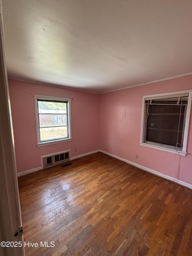 1208 S 9th St, Wilmington, NC 28401 - empty room with wood finished floors, baseboards, and ornamental molding