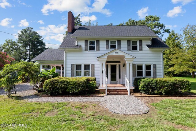 colonial home with a front lawn