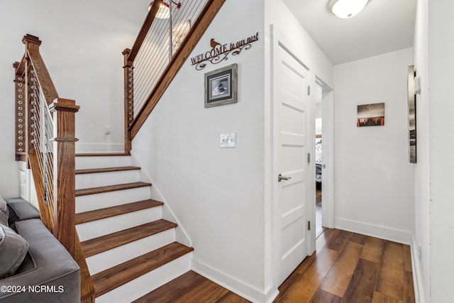 stairway featuring baseboards and wood finished floors