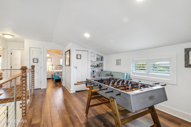 game room with lofted ceiling, built in shelves, recessed lighting, baseboards, and dark wood finished floors