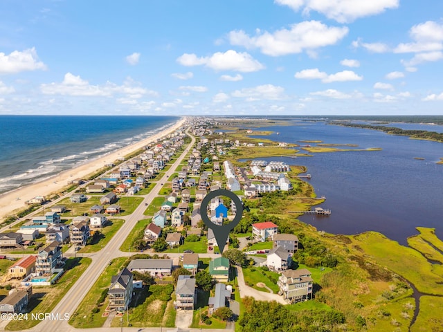 birds eye view of property featuring a water view, a residential view, and a view of the beach