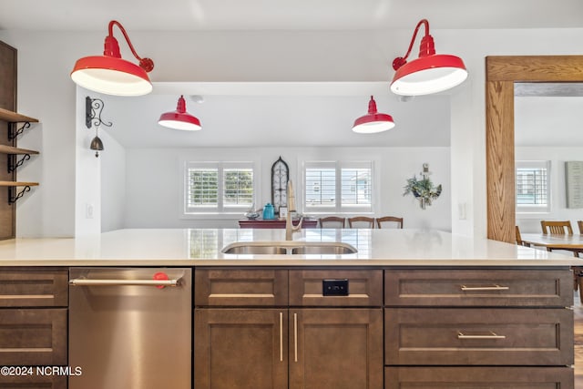 kitchen with dark brown cabinetry, a sink, light countertops, dishwasher, and open shelves