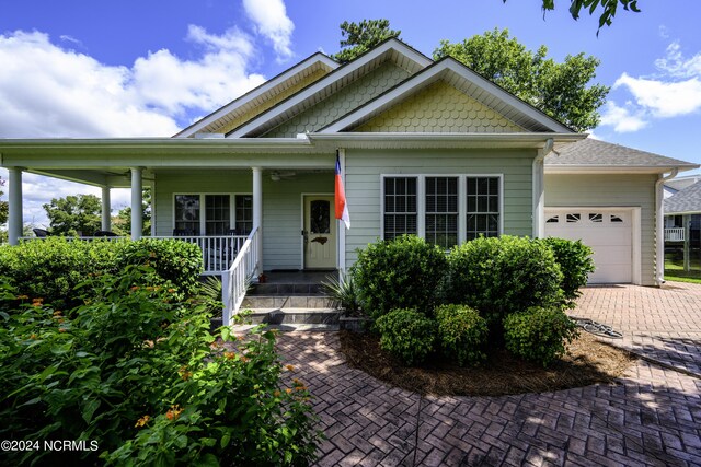 view of front of home featuring a garage and a porch